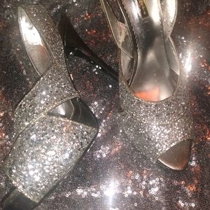 Silver glitter, 2 toes out, slight heel damage.